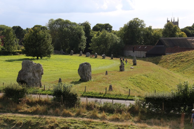 Part of the stone circle and Avebury village from the top of the henge