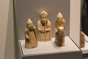 Three of the 78 Lewis Chessmen.  These medieval walrus ivory chess pieces were found in Western Scotland in 1831. Half of them were painted red instead of the black we use today.