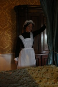 One of the maids making the bed upstairs -- the dialog in this room was between her and a footman, who told her to keep her head down, do a good job, and the Countess would be inviting her to the theater in no time... riiiiight.